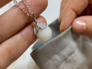 Placing Breast Milk Necklace into Gift Bag - BreastMilk Keepsake Ideas - KeepsakeMom
