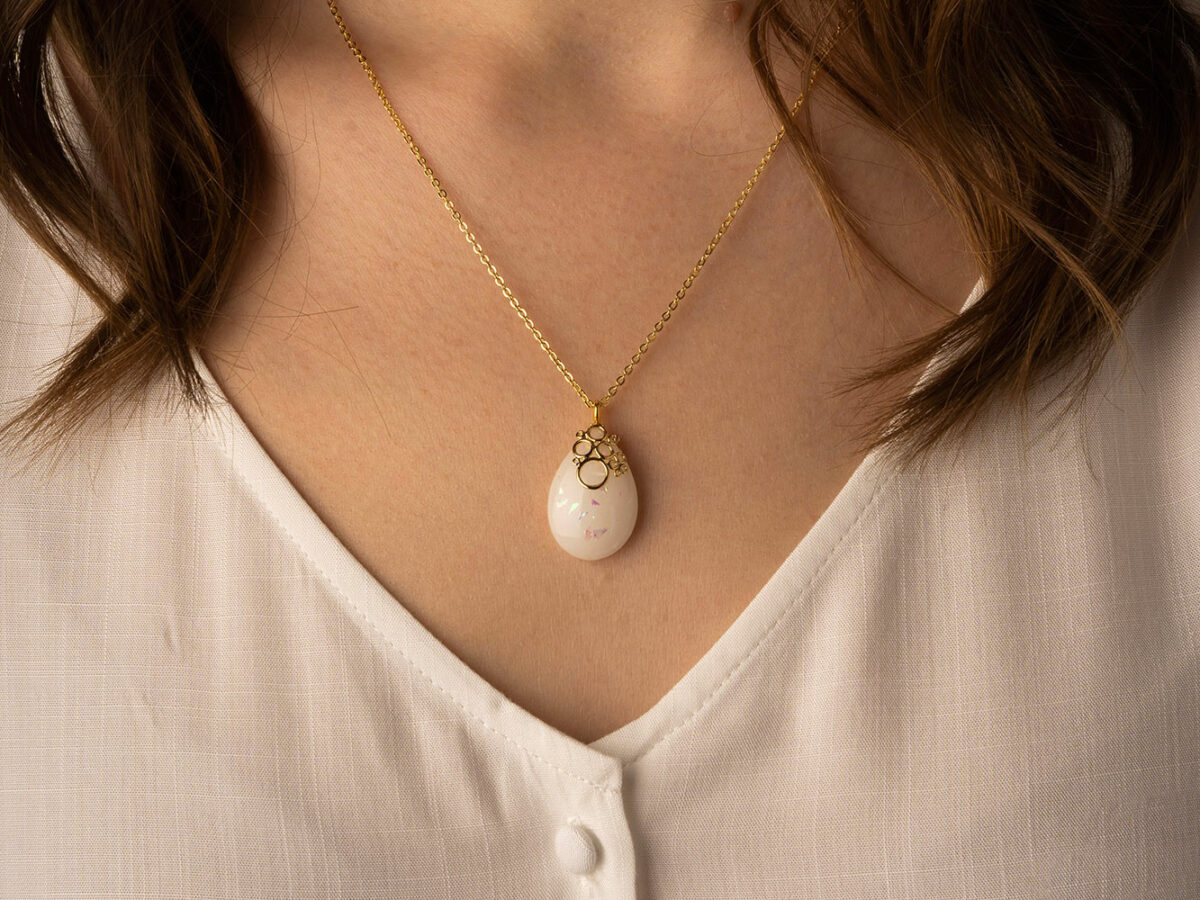 Breastmilk jewelry necklace pendant drop teardrop shape with opal effect flakes and fancy bail from KeepsakeMom model