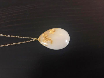 breast milk jewelry the original gold teardrop or drop necklace with gold flakes from KeepsakeMom