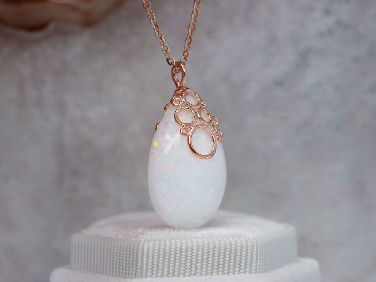 Breastmilk jewelry necklace pendant drop teardrop shape with opal real crushed gems and fancy rose gold bubbles bail from KeepsakeMom