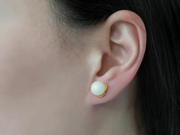 breastmilk jewelry earrings on a model ear from KeepsakeMom simple pearl studded
