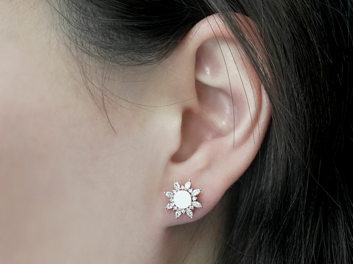 breastmilk jewelry earrings on a model ear from KeepsakeMom fancy star studded earring