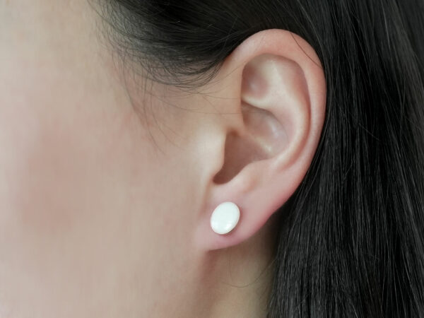 breastmilk jewelry earrings on a model ear from KeepsakeMom oval simple studded