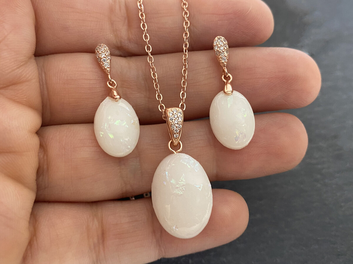 breastmilk jewelry set oval earrings and necklace from KeepsakeMom rose gold setting hand shown