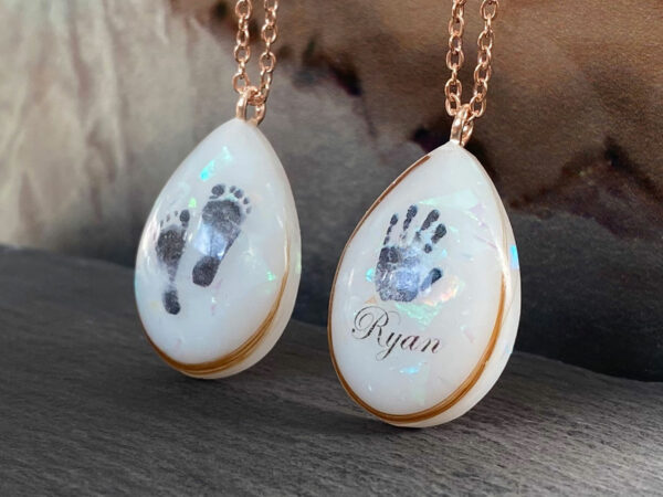 breastmilk jewelry necklaces teardrop with baby foot and handprints hair opal effect flakes and name KeepsakeMom
