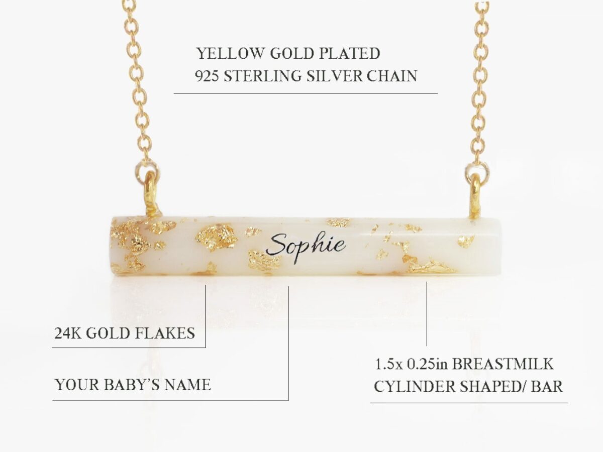 breast milk necklace pendant cylinder stick shape with yellow gold flakes throughout and name in the middle on white background feature describing diagram from keepsakemom