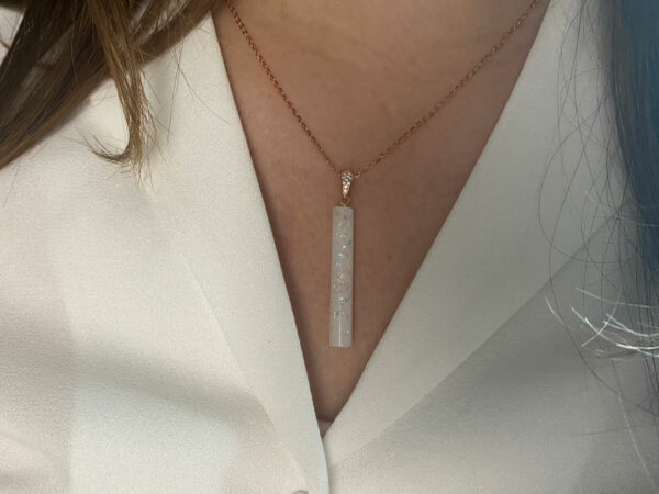 breastmilk jewelry stick bar necklace from Keepsakemom with opal flakes and rose chain, model