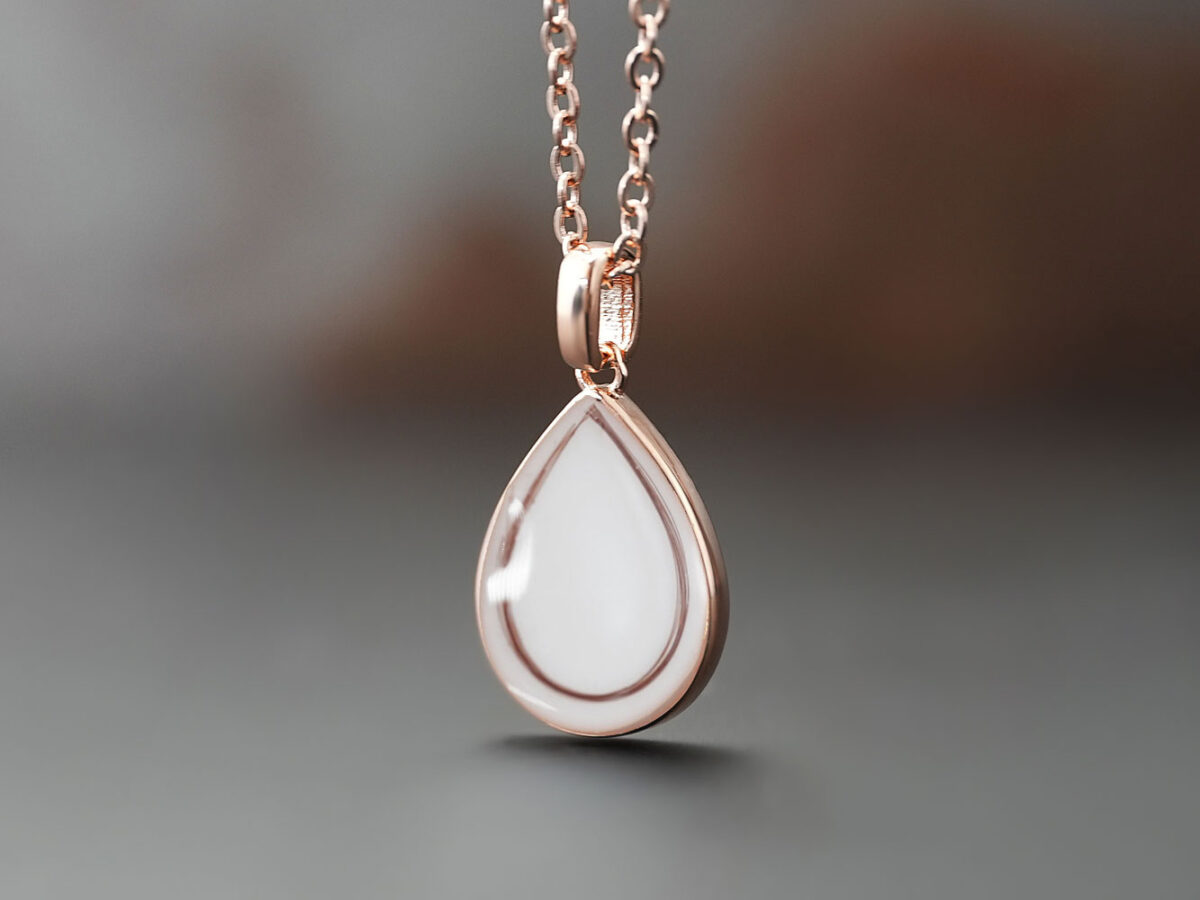 breastmilk jewelry rose gold teardrop filled with breastmilk with teardrop shaped lock of hair from KeepsakeMom