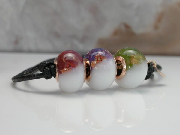 breastmilk three beads bracelet with birth month colors ruby, alexandrite and peridot on a waxed black cord on white background from KeepsakeMom