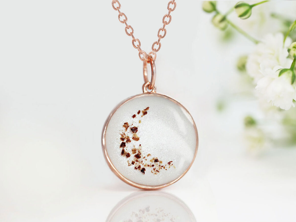 breastmilk jewelry disc necklace pendant from keepsakemom in a 18mm disc filled with breastmilk, with placenta forming crescent moon and light purple alexandrite charm for june from keepsakemom