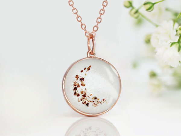 breastmilk jewelry disc necklace pendant from keepsakemom in a 18mm disc filled with breastmilk, with placenta forming crescent moon and light purple alexandrite charm for june from keepsakemom