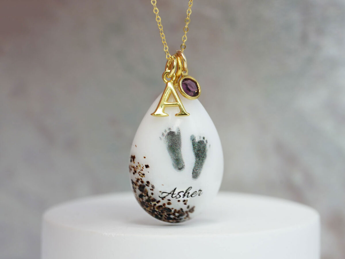 breastmilk jewelry necklace with placenta, umbilical cord and ashes in yellow gold plating teardrop with baby feet and charms from keepsakemom