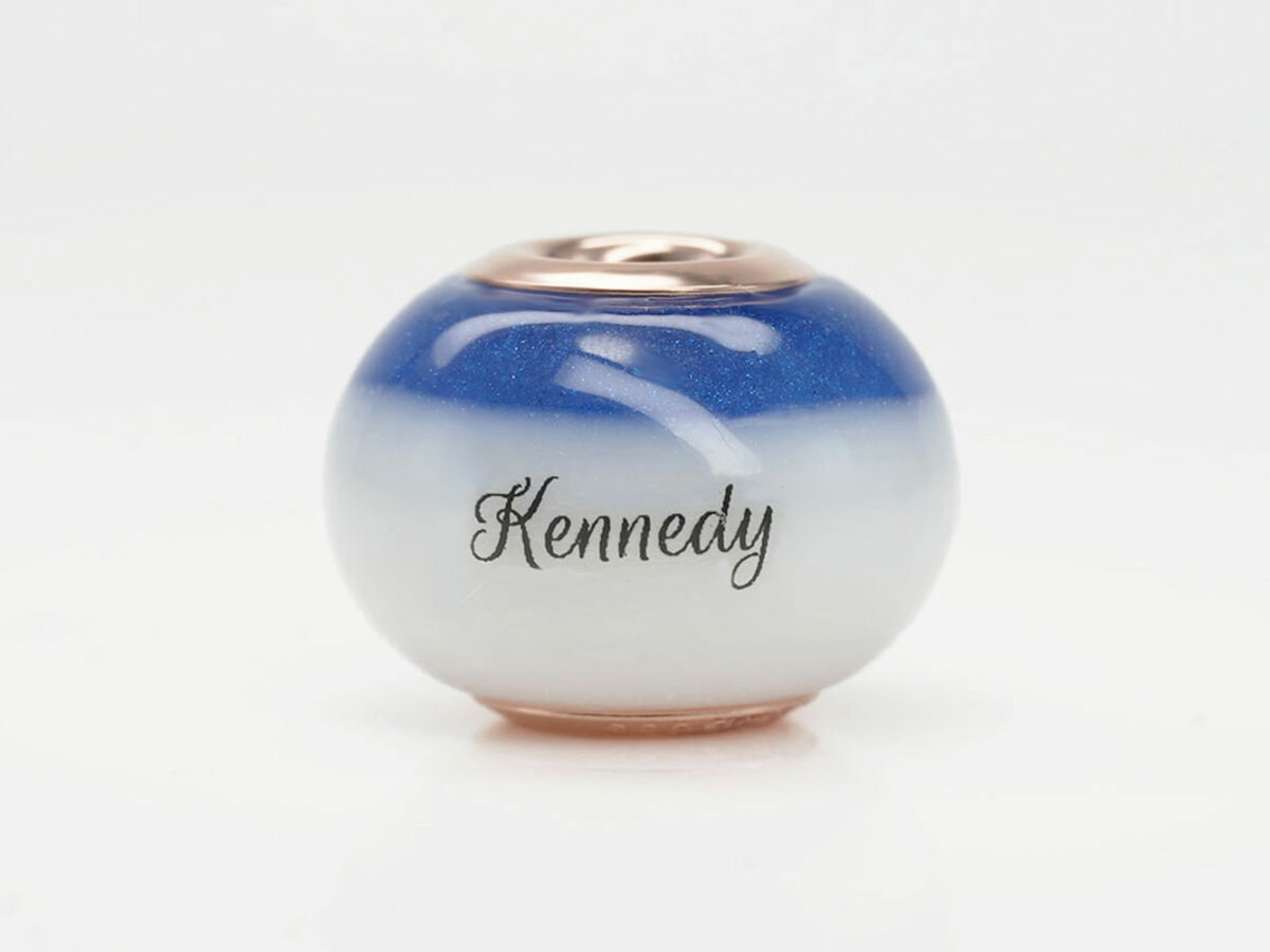 breast milk bead with milk on the bottom and sapphire blue color at the top with baby's name from keepsakemom