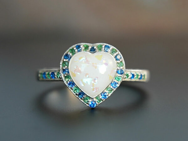breastmilk ring heart with birth month crystals from KeepsakeMom with opal effect flakes green blue crystals