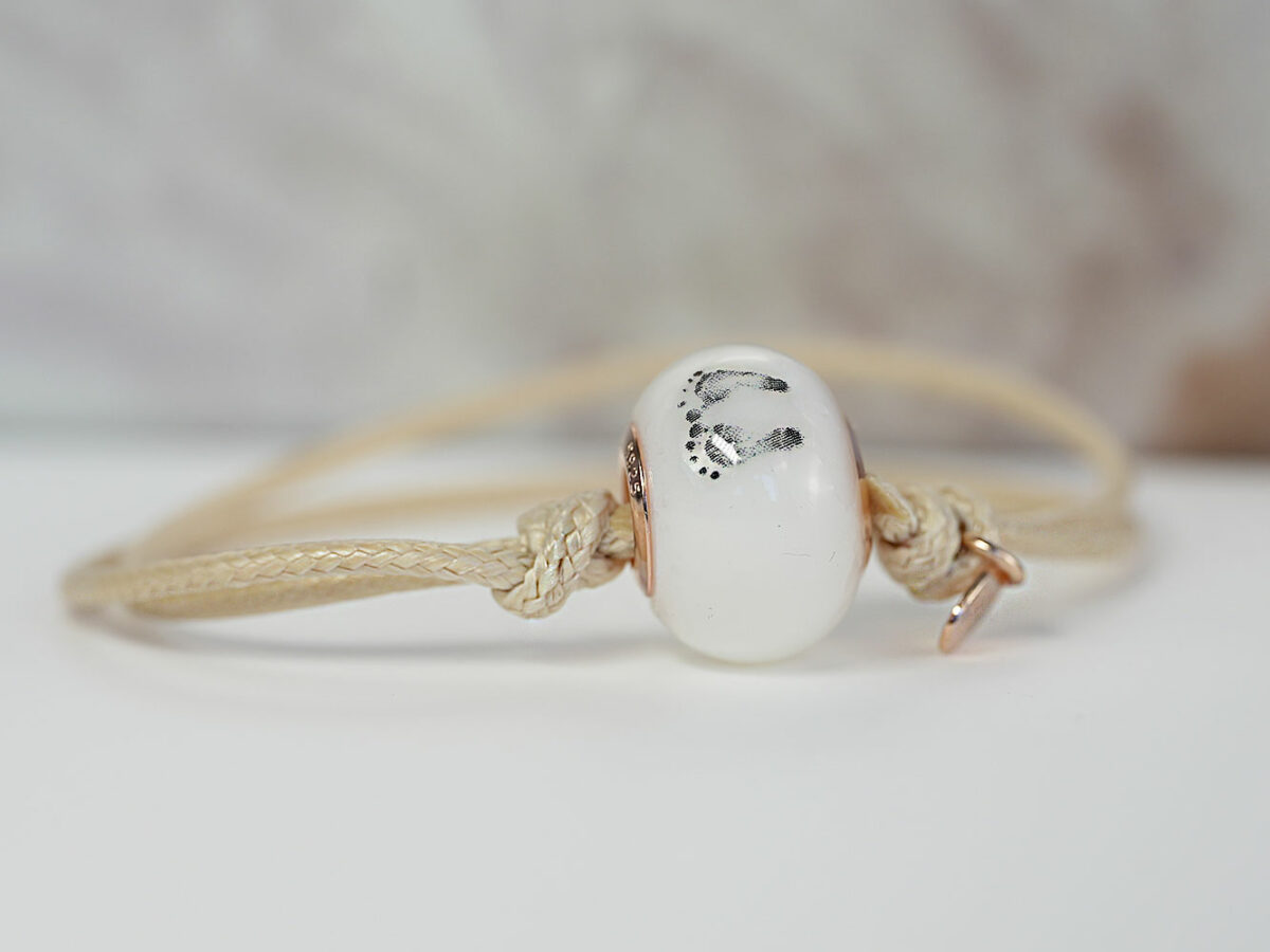 breastmilk jewelry bead light wheat color cord bracelet with rose gold bead cores foot prints from keepsakemom