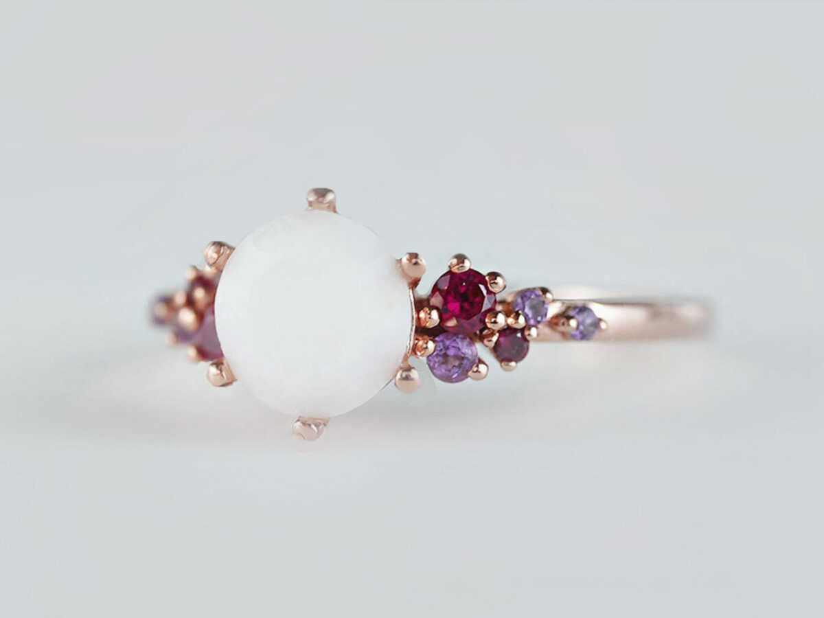 breastmilk jewelry silver ring diamond shaped milk stone and five gems on each side purple and ruby birth month colors from KeepsakeMom