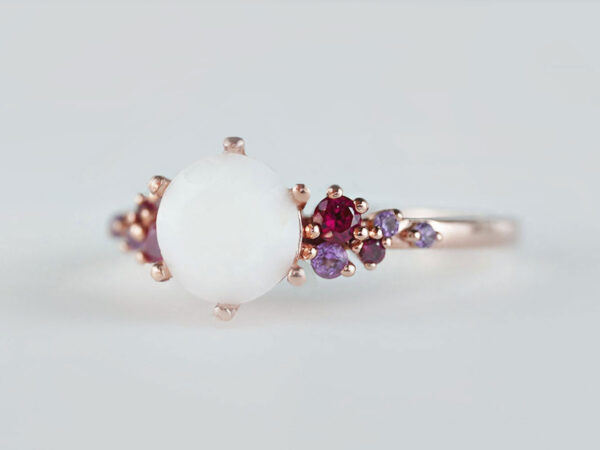 breastmilk jewelry silver ring diamond shaped milk stone and five gems on each side purple and ruby birth month colors from KeepsakeMom