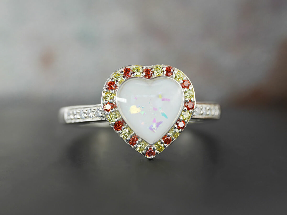 breastmilk ring heart with birth month crystals yellow and red from KeepsakeMom with opal flakes