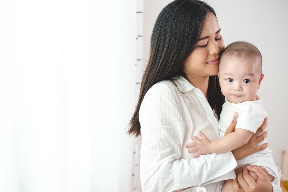 Young mother holding baby
