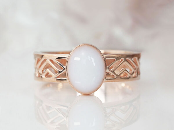 rose gold plated sterling silver with negatively spaced rectangular slits in a thick band with an oval shaped breast milk stone from KeepsakeMom