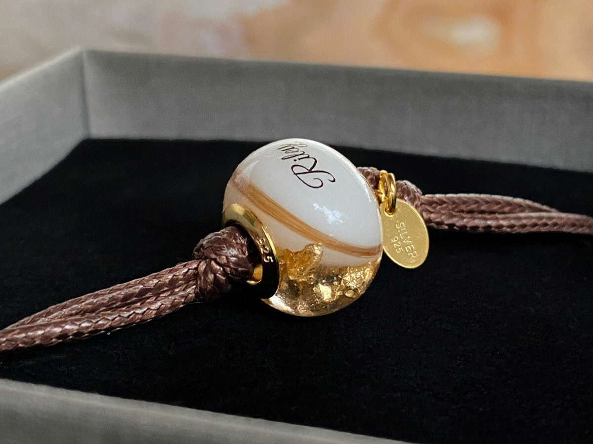 breastmilk jewelry bead bracelet with hair inclusions flakes yellow gold child's name and lock of hair keepsakemom
