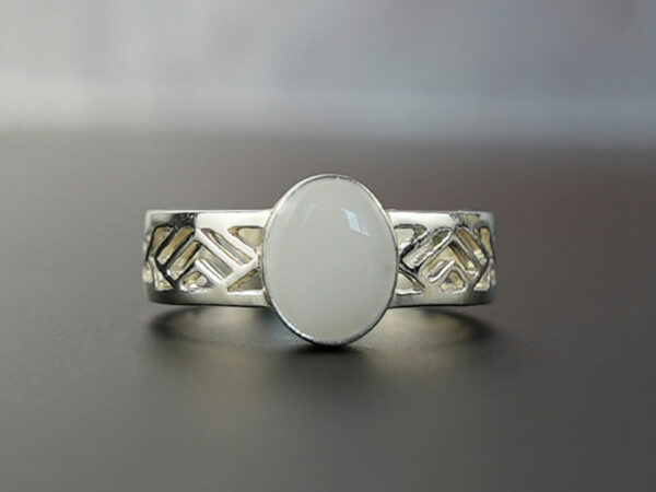 sterling silver with negatively spaced rectangular slits in a thick band with an oval shaped breast milk stone from KeepsakeMom