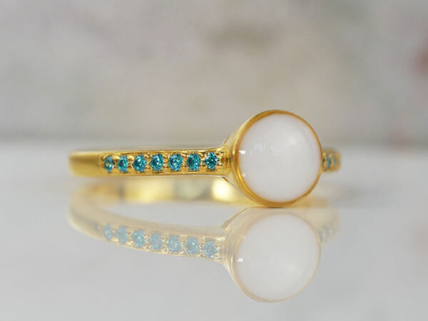 breastmilk ring in yellow gold with round breastmilk stone and side crystals blue from keepsakemom