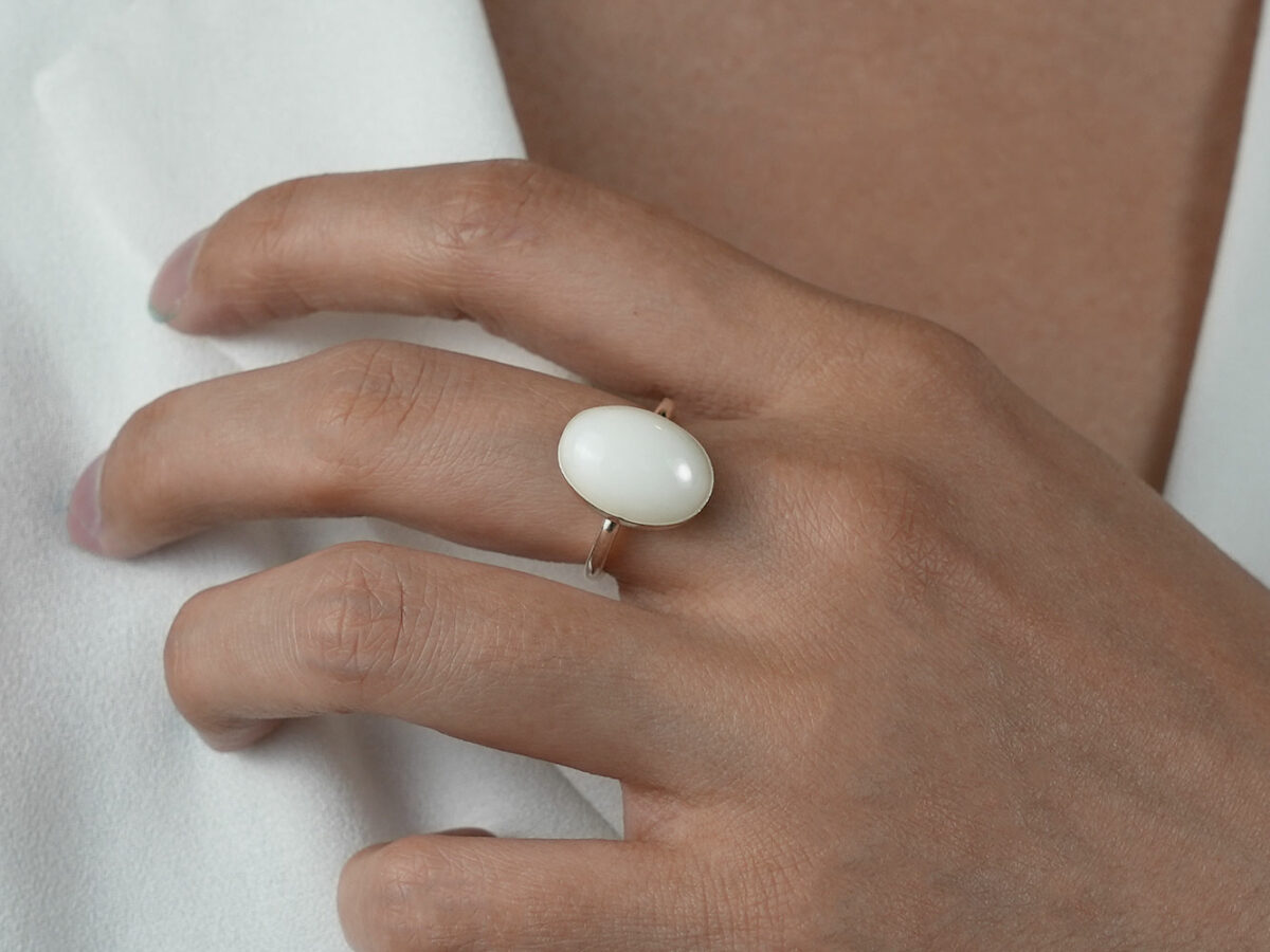 breastmilk jewelry rose gold plated sterling silver oval-shaped breast milk ring flakes from KeepsakeMom on a model hand