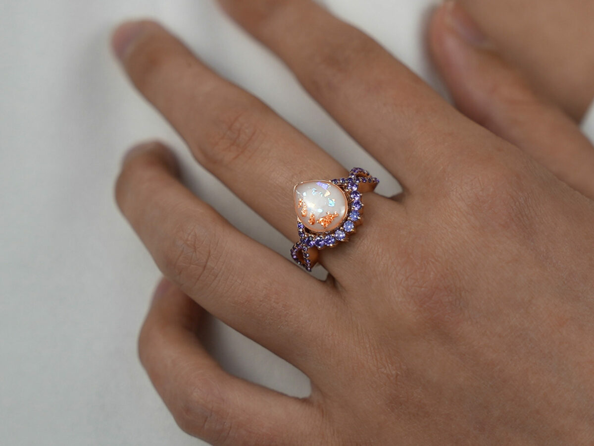 breastmilk jewelry ring crystals teardrop birth month color crystals teardrop from KeepsakeMom rose gold opal rose gold flakes model hand