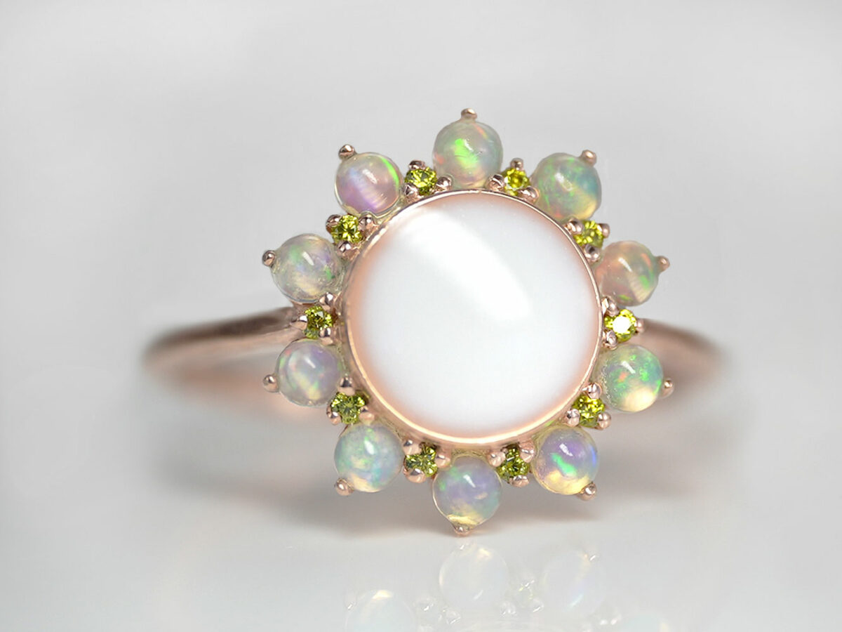 rose gold plated sterling silver sunflower-looking ring with real opal gems for petals and peridot crystals as smaller petals with round-shaped breast milk stone from KeepsakeMom