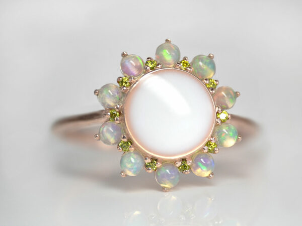 rose gold plated sterling silver sunflower-looking ring with real opal gems for petals and peridot crystals as smaller petals with round-shaped breast milk stone from KeepsakeMom
