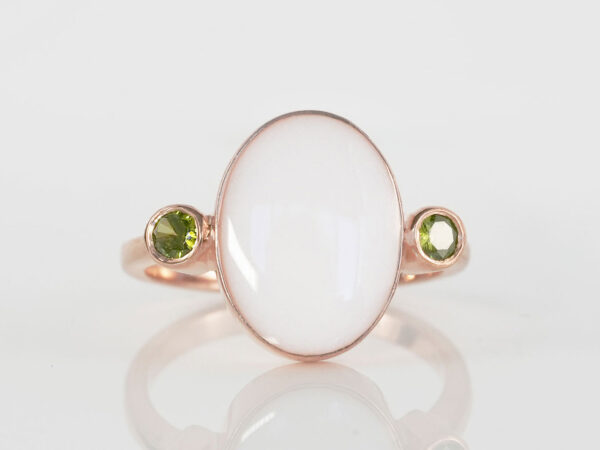 breastmilk jewelry oval breast milk stone ring two birth month crystals green peridot august on each side in rose gold setting from KeepsakeMom