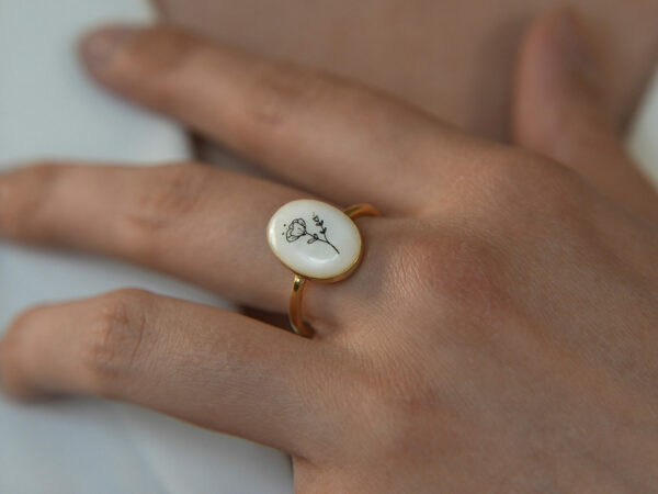 breastmilk ring oval flower birth month color stones from KeepsakeMom model hand