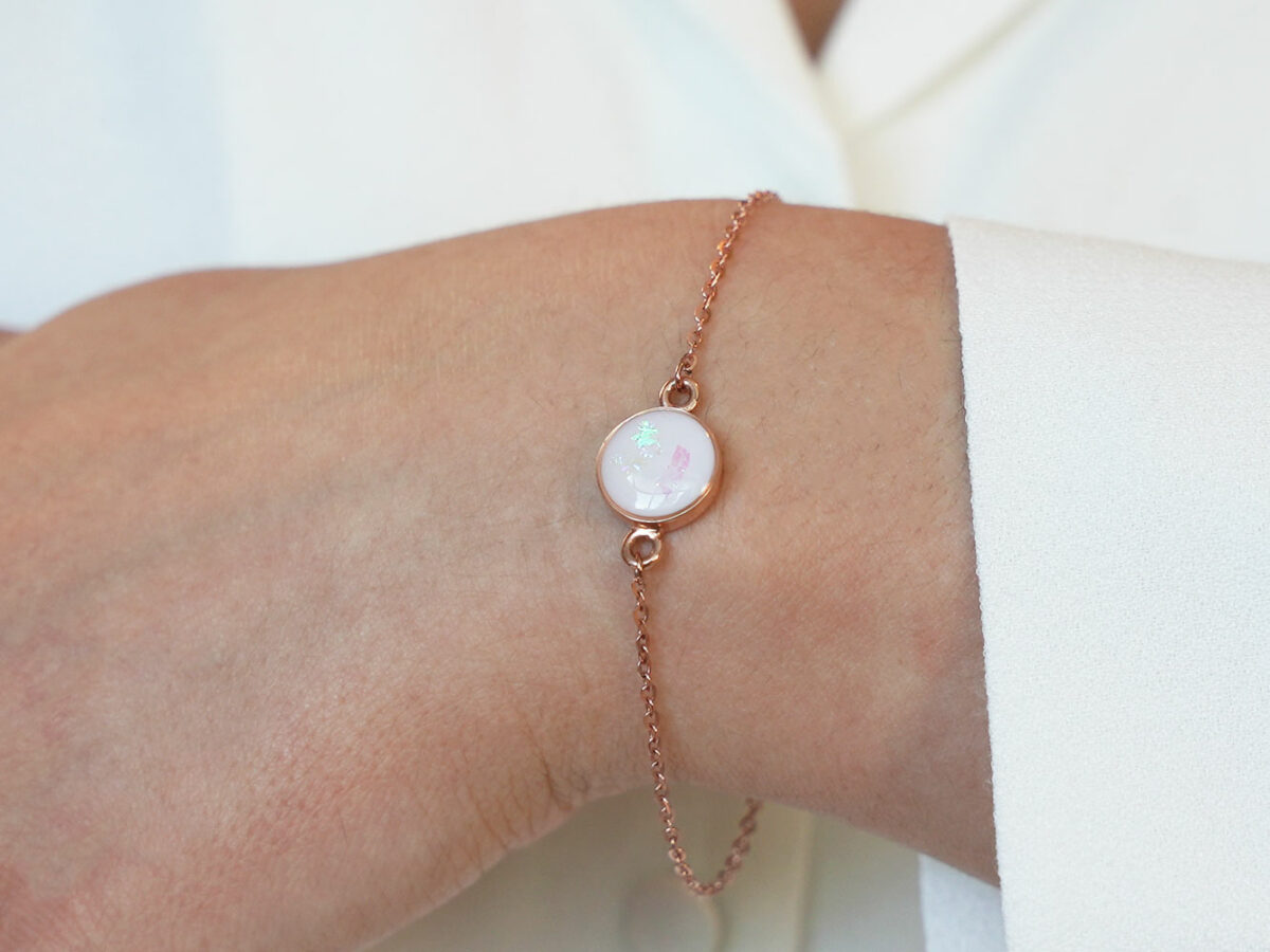 breastmilk jewelry disc bracelet opal flakes rose gold keepsakemom on a model wrist