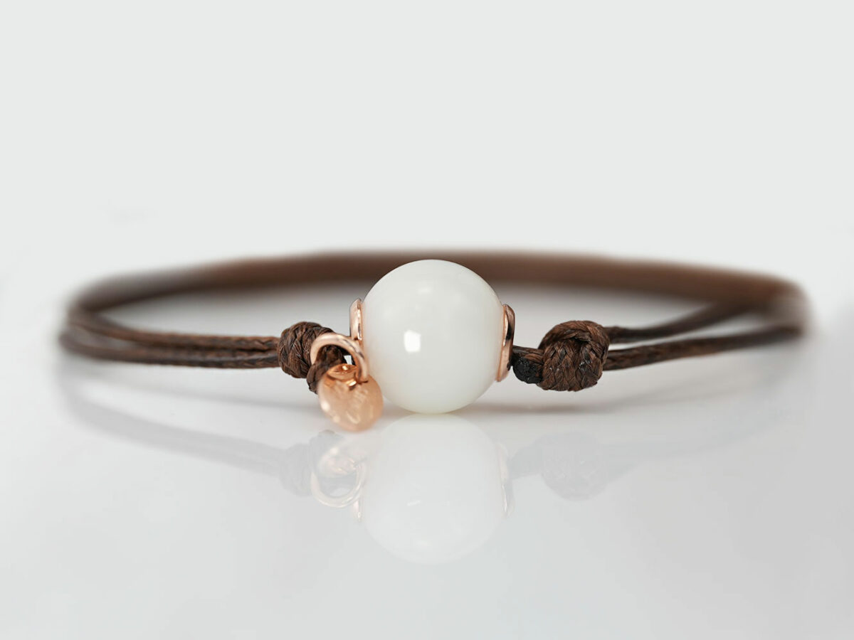 breastmilk one simple pearl made with breastmilk on a brown cord with rose gold tag on white background from keepsakemom