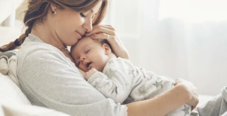 Happy mother holding her newborn baby