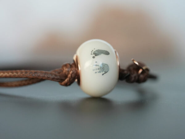 breastmilk jewelry bead brown cord bracelet with rose gold bead cores foot print hand print keepsakemom