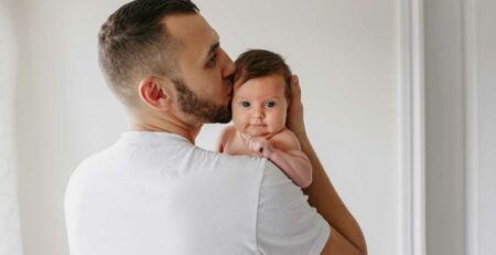 Father holding newborn baby