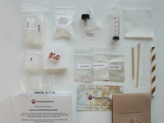 Contents of DIY Breastmilk Jewelry Kit with Steps Taken Out of Box and Laid Out on Table - KeepsakeMom