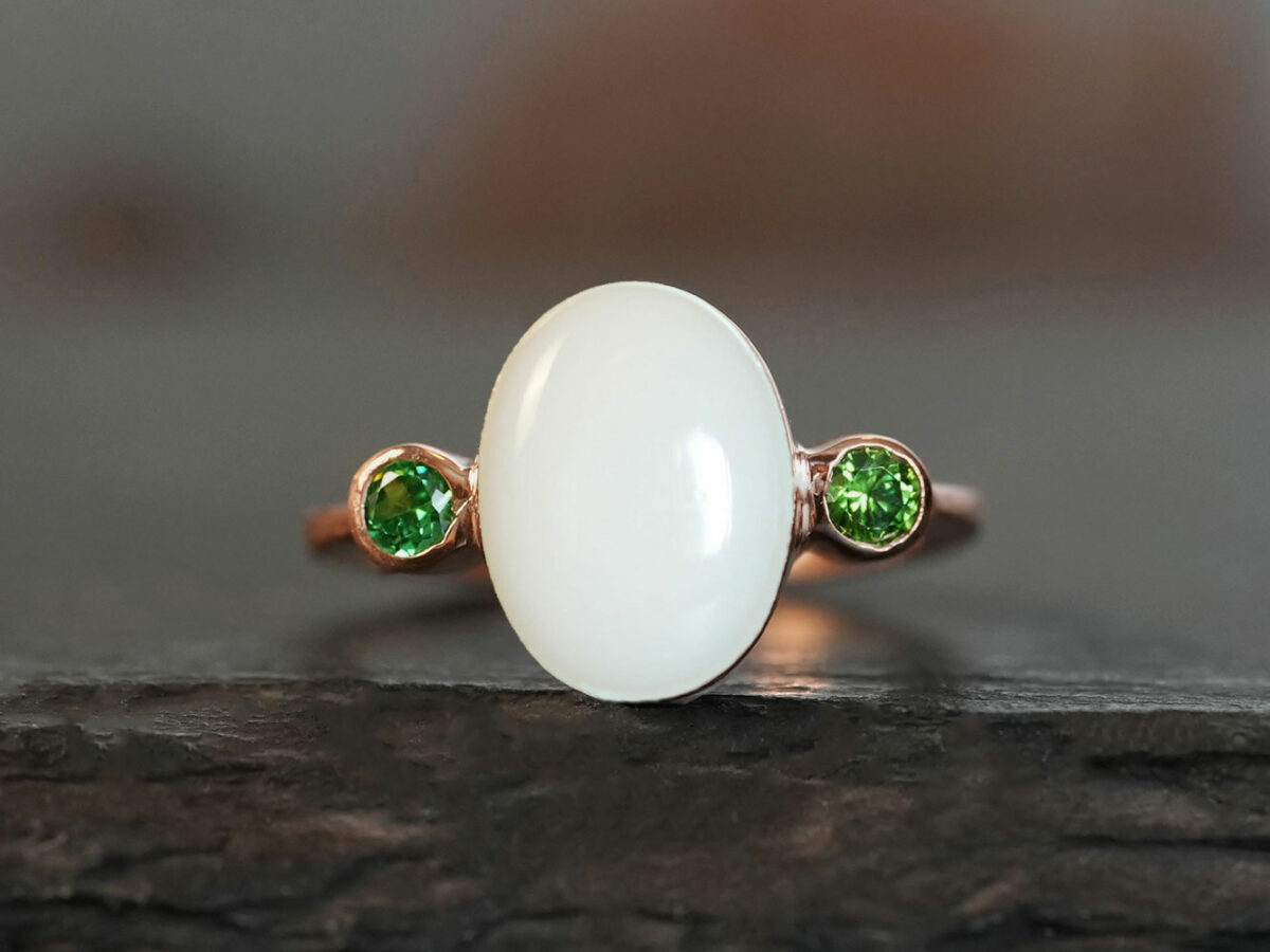 breastmilk jewelry oval breast milk stone ring two birth month crystals green peridot august on each side in rose gold setting from KeepsakeMom
