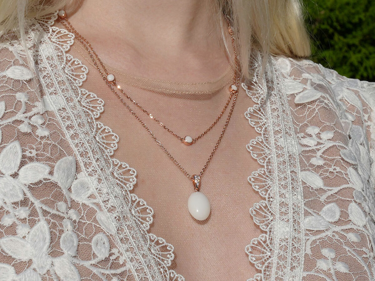 breastmilk jewelry necklaces model in white dress from KeepsakeMom