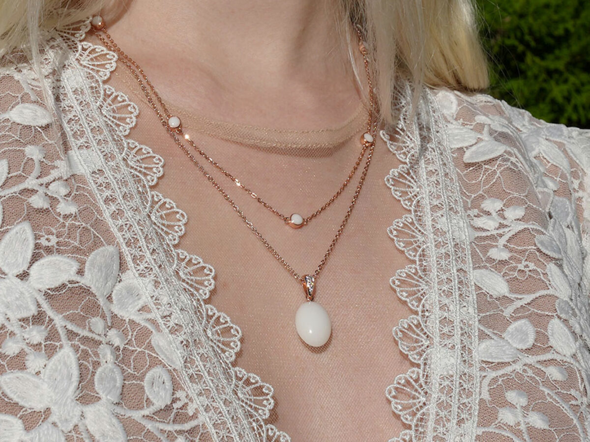breastmilk jewelry necklaces model in white dress from KeepsakeMom