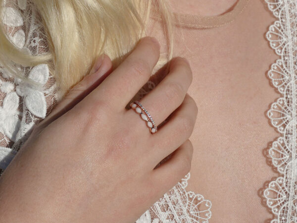 breastmilk jewelry model in white dress wearing fine band ring set from KeepsakeMom