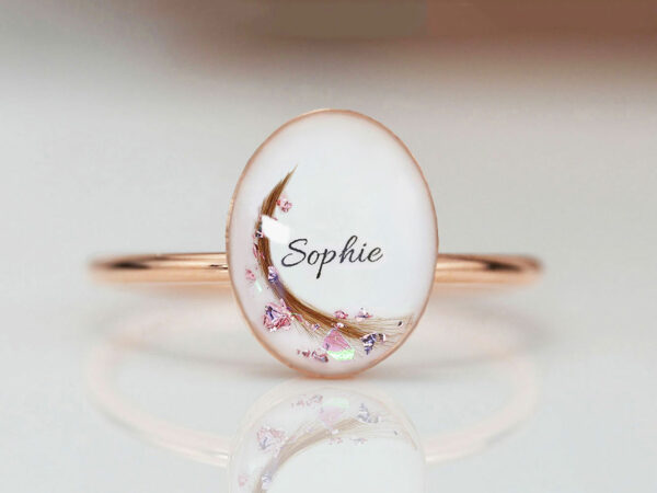 breastmilk jewelry rose gold plated sterling silver oval-shaped breast milk ring with name and lock of hair from KeepsakeMom on light background