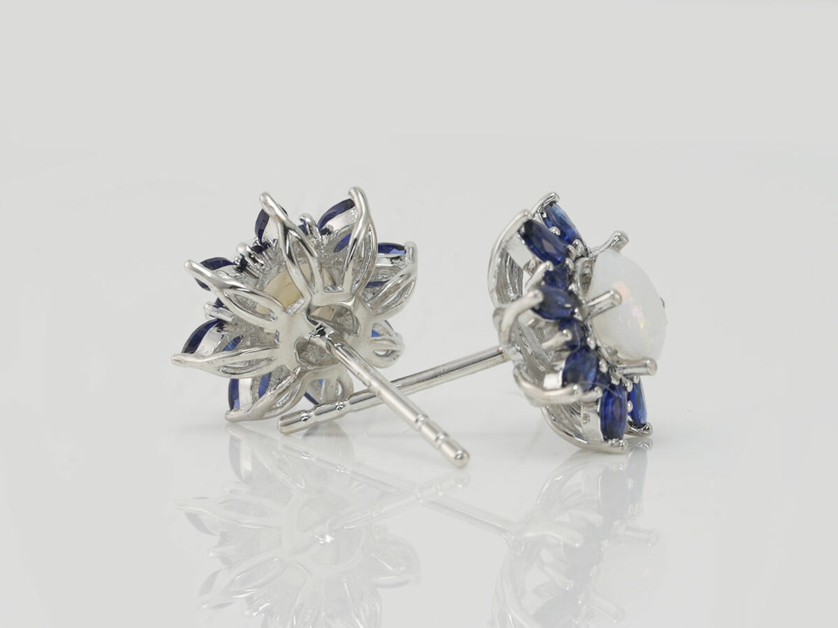 breastmilk jewelry fancy star or flower shaped studded earrings with birth month colored gems sapphire blue as leaves from KeepsakeMom on white background shown from the back