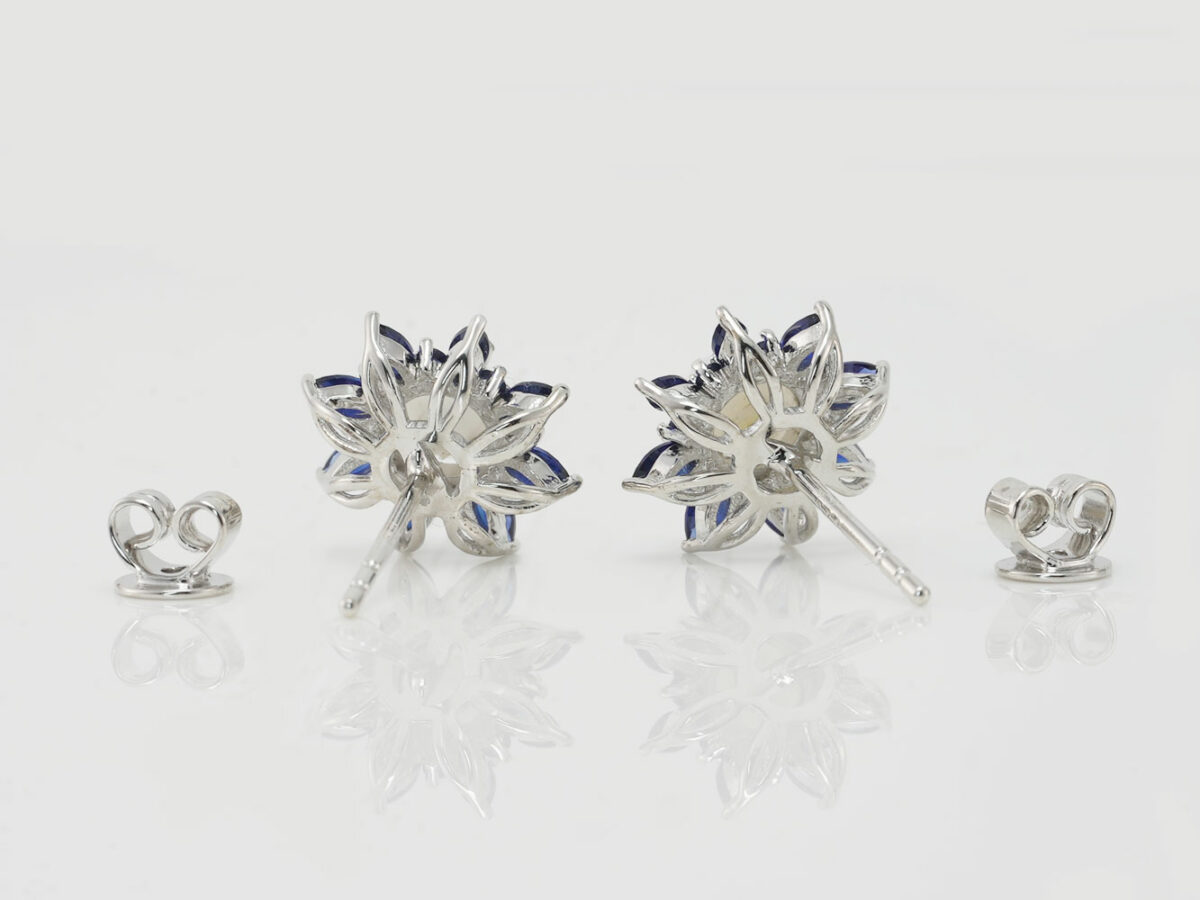 breastmilk jewelry fancy star or flower shaped studded earrings with birth month colored gems sapphire blue as leaves from KeepsakeMom on white background shown from the back