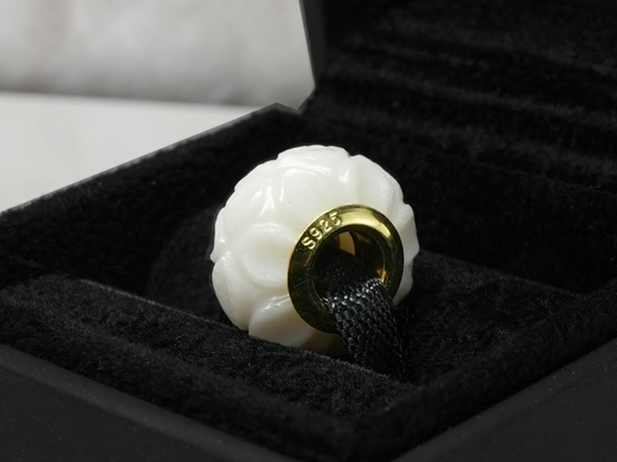 breastmilk jewelry flower bead with yellow gold in jewelry box keepsakemom