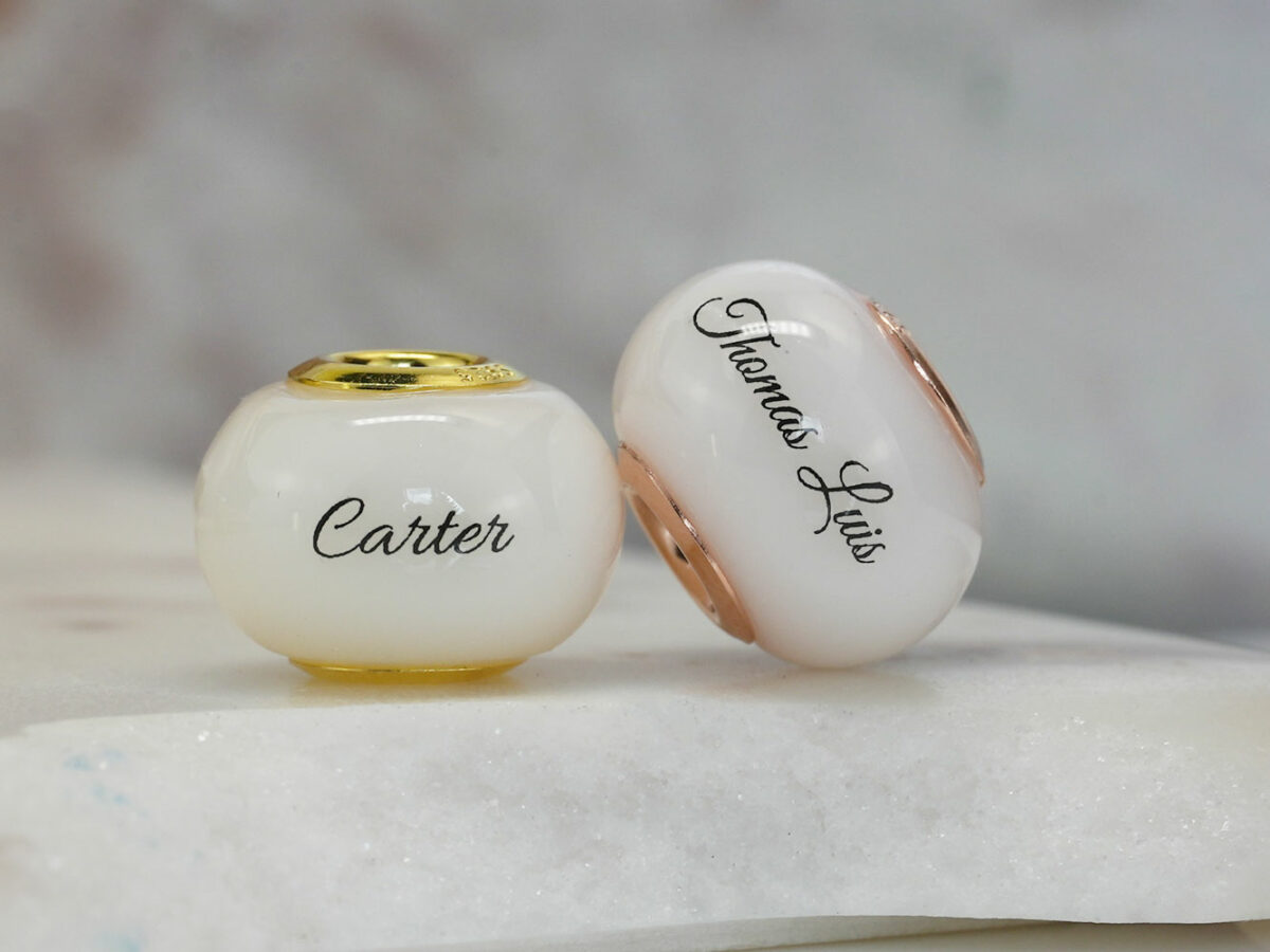 two breastmilk jewelry beads with rose and yellow gold yellow gold child's name from KeepsakeMom
