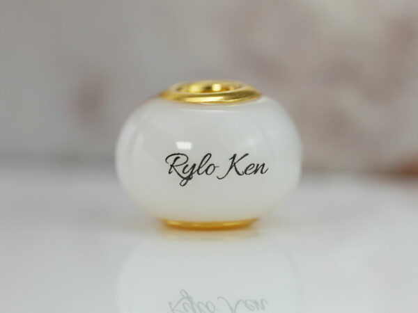 breastmilk jewelry bead with yellow gold cores and child's name from KeepsakeMom