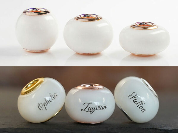multiple breastmilk jewelry beads different shapes and sizes with rose gold bead cores from keepsakemom on white and dark background with names, dates and hair in the beads